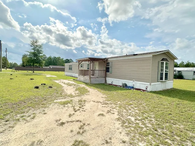 a view of a swimming pool with a yard