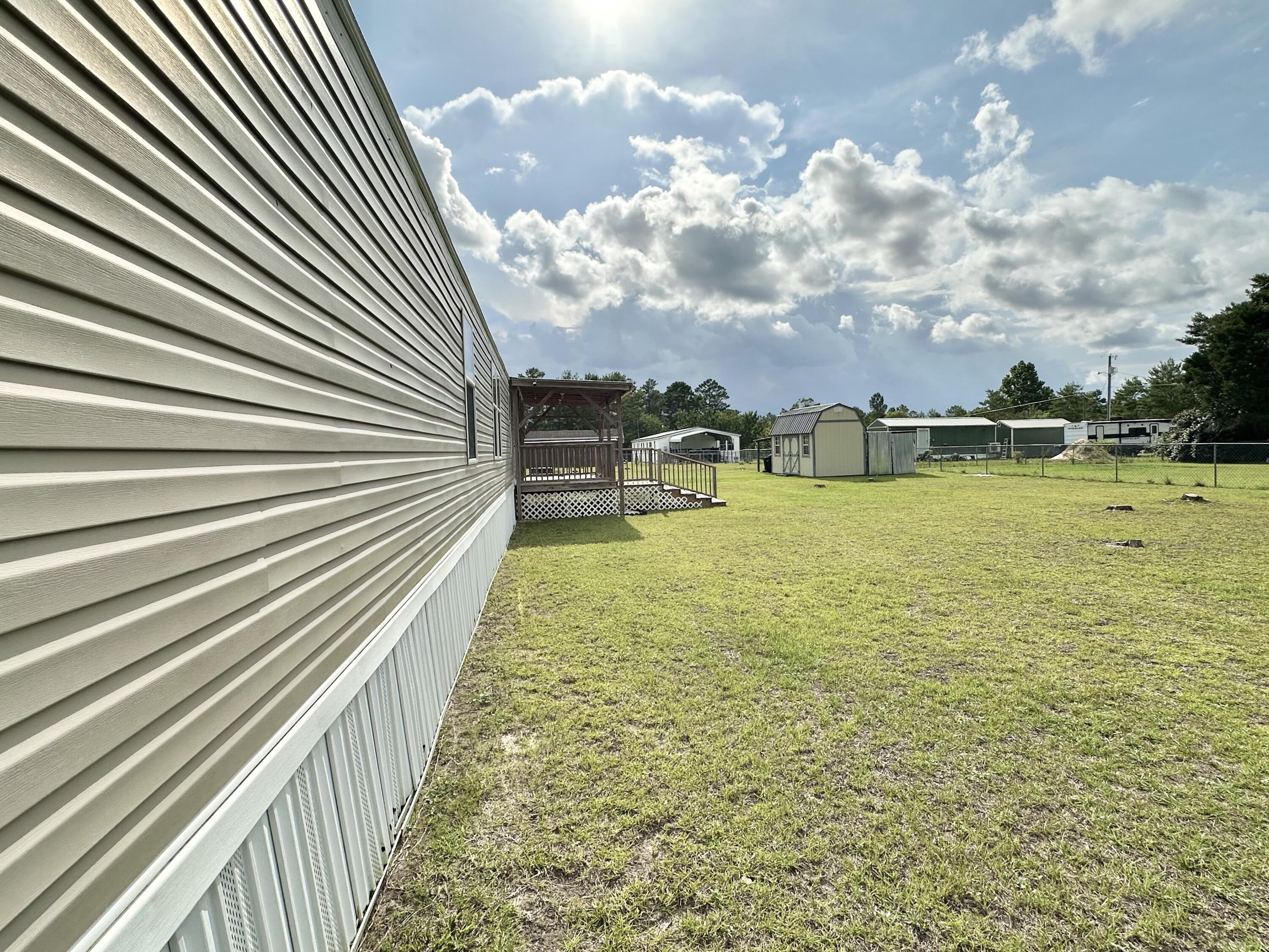 123 Marigold Avenue DeFuniak Springs, FL 32433 - Photo 43 of 45 a view of a swimming pool with an outdoor seating