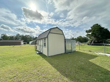 a view of a house with yard and a garden