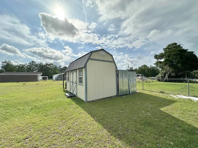 a view of a house with yard and a garden