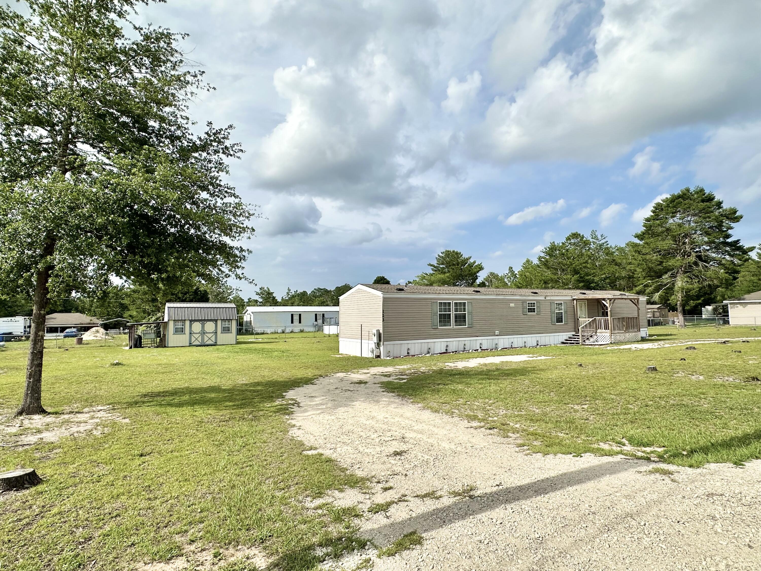 123 Marigold Avenue DeFuniak Springs, FL 32433 - Photo 45 of 45 a view of a swimming pool with a yard