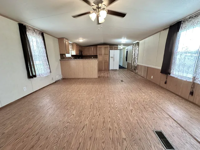 a view of a livingroom with furniture wooden floor and window