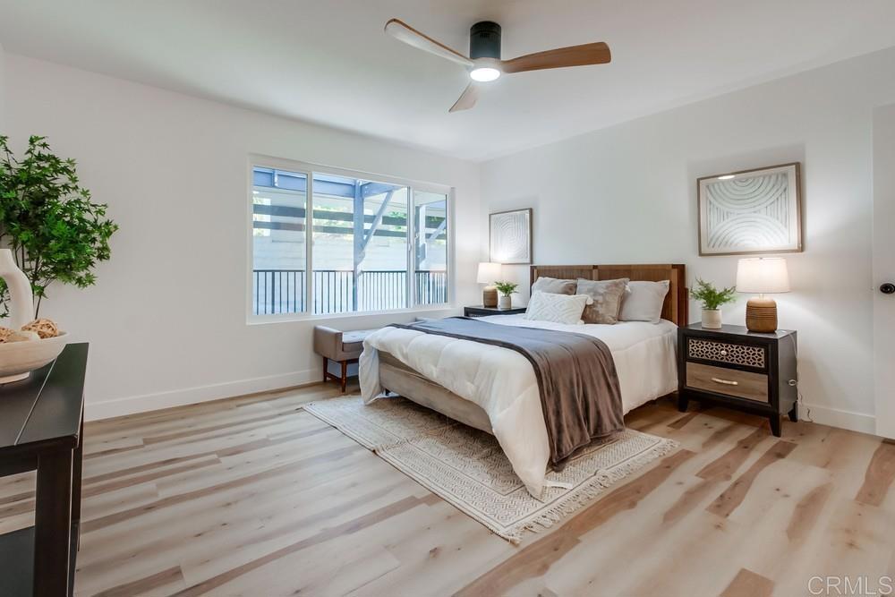 3606 Vista Rey, Unit 37 Oceanside, CA 92057 - Photo 23 of 45 a bedroom with a large bed and a chandelier