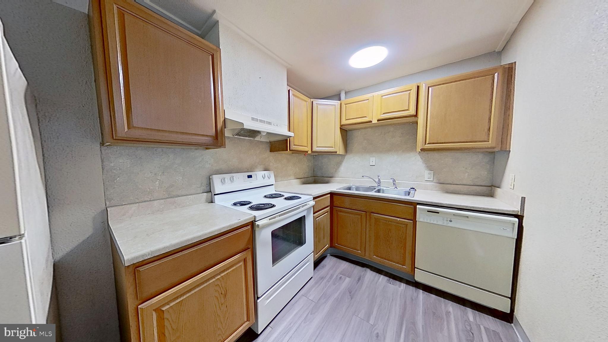155 West Main Street, Unit 17 Windsor, PA 17366 - Photo 4 of 8 a kitchen with a stove top oven sink and cabinets