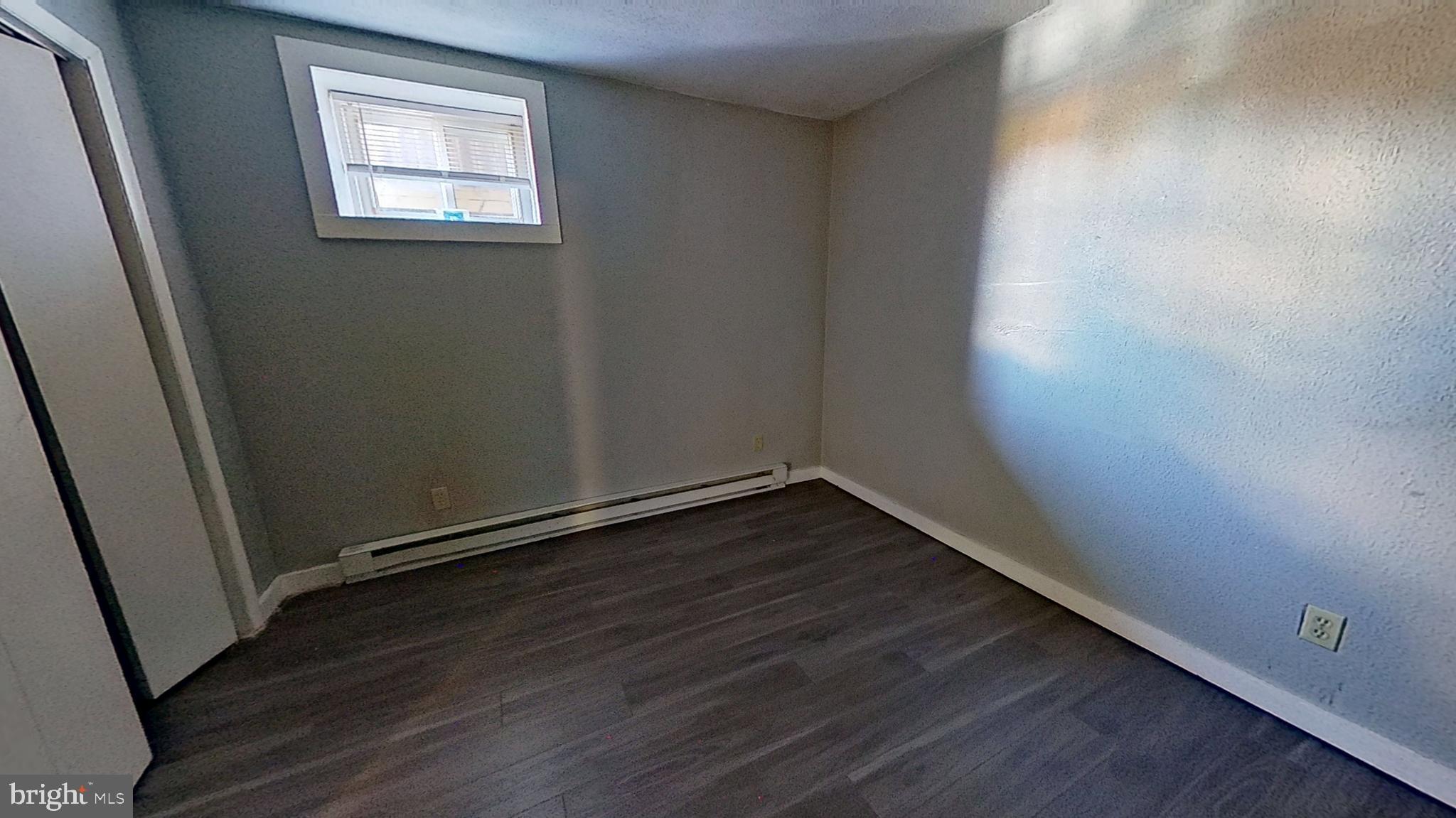 155 West Main Street, Unit 17 Windsor, PA 17366 - Photo 5 of 8 a view of an empty room with wooden floor and a window