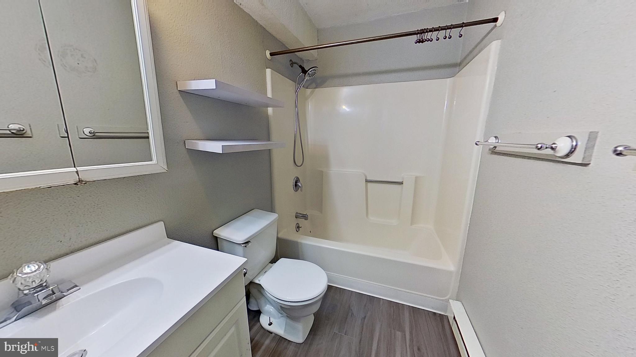 155 West Main Street, Unit 17 Windsor, PA 17366 - Photo 6 of 8 a white toilet sitting next to a bathroom sink
