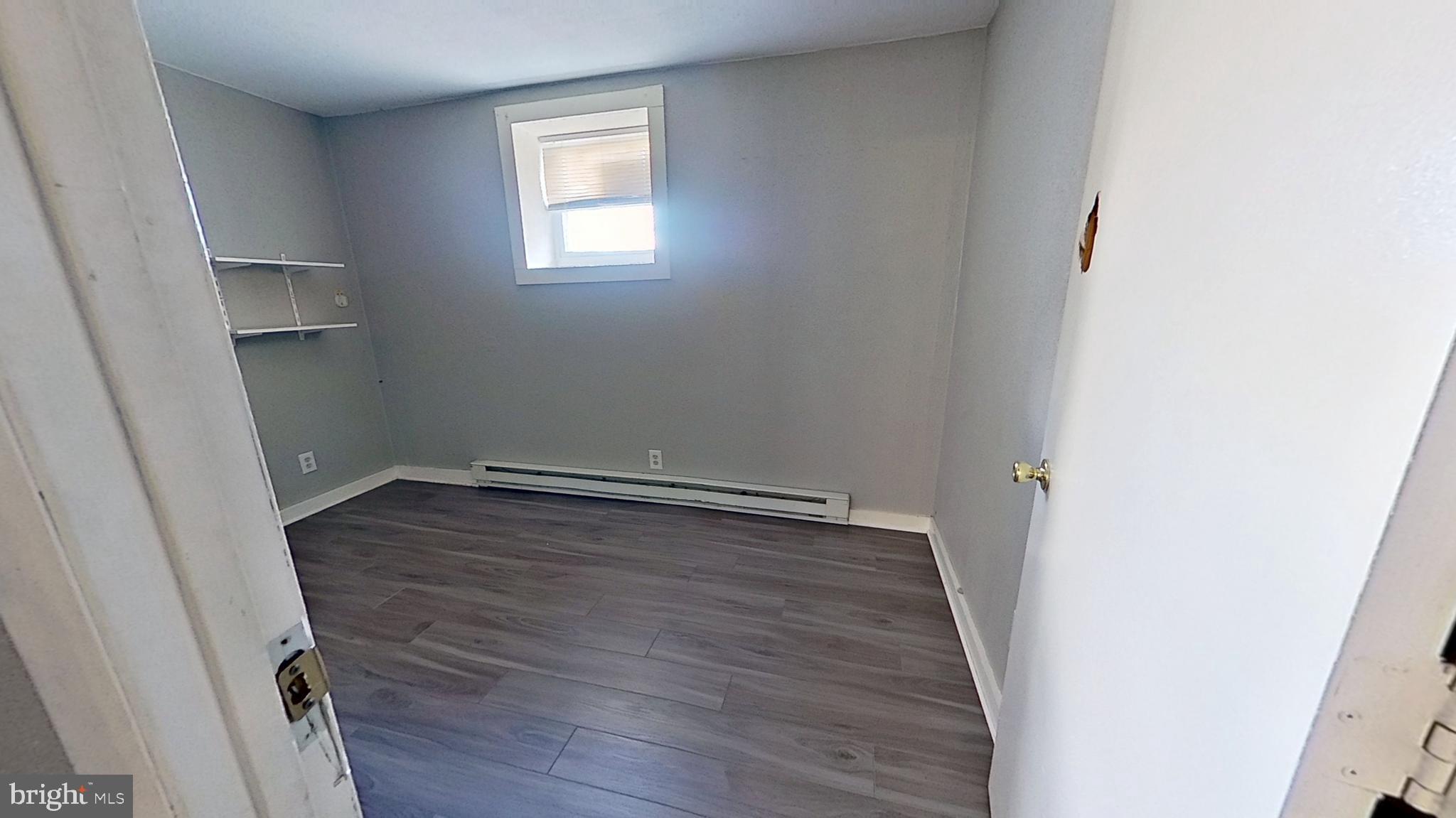 155 West Main Street, Unit 17 Windsor, PA 17366 - Photo 7 of 8 an empty room with wooden floor and window