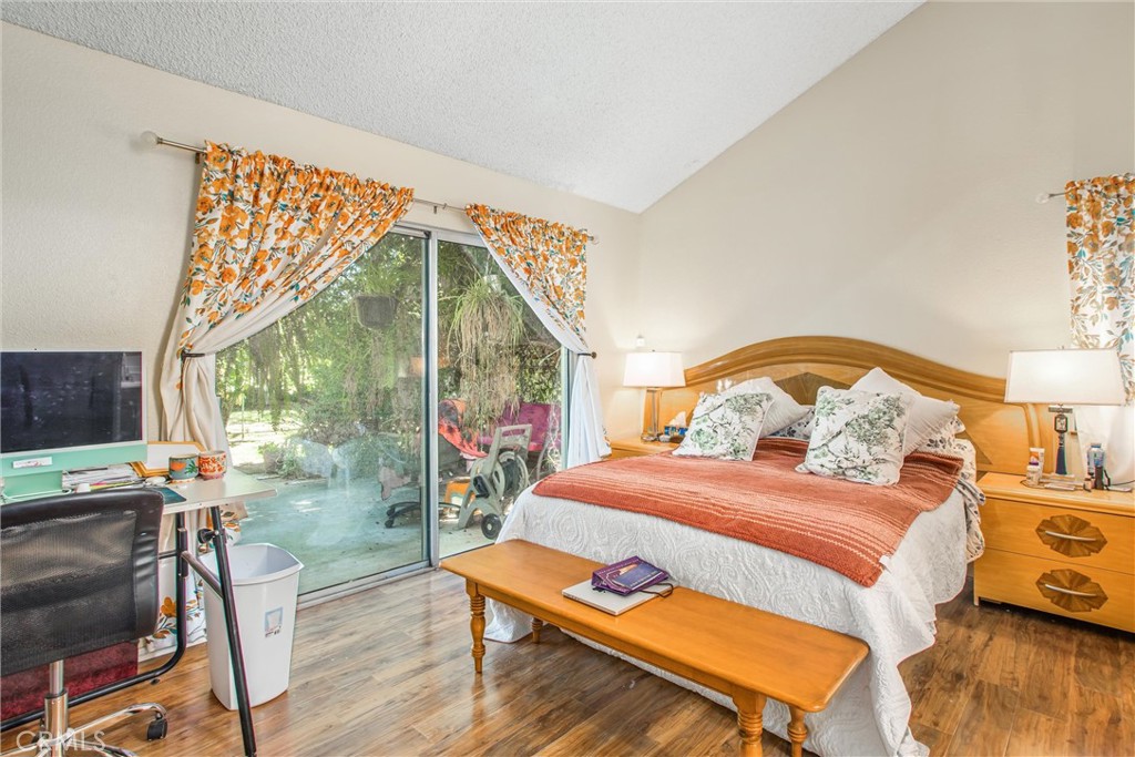 13503 Mulberry Circle Yucaipa, CA 92399 - Photo 17 of 28 a bedroom with a bed and wooden floor