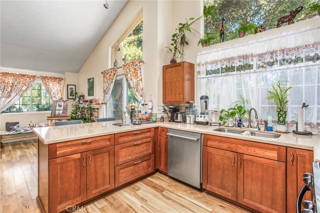 13503 Mulberry Circle Yucaipa, CA 92399 - Photo 8 of 28 a kitchen with stainless steel appliances a sink window and cabinets