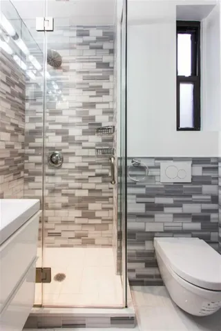 a bathroom with a toilet and a shower