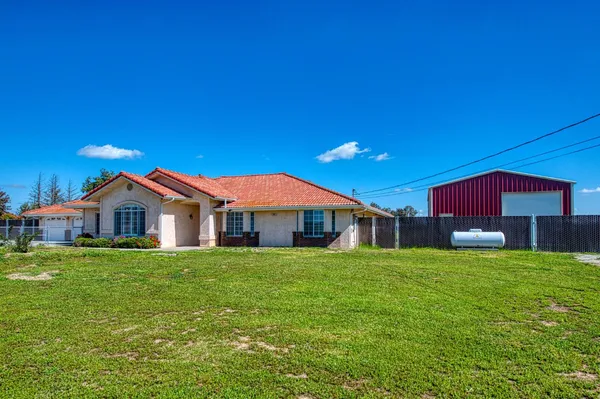 a view of a house with a yard