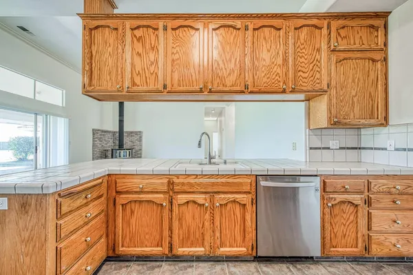 a view of a grassy field with an trees
