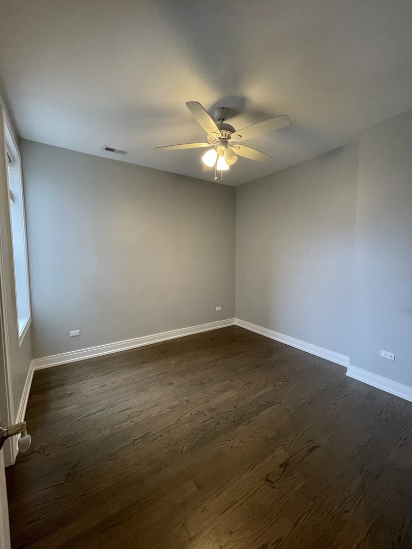 2036 West 18th Street, Unit 4 Chicago, IL 60608 - Photo 16 of 29 an empty room with a empty space and a ceiling fan