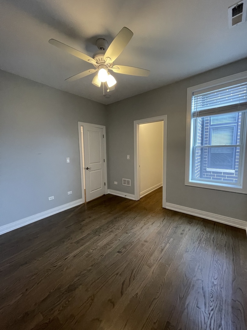 2036 West 18th Street, Unit 4 Chicago, IL 60608 - Photo 18 of 29 a view of an empty room with wooden floor and a window