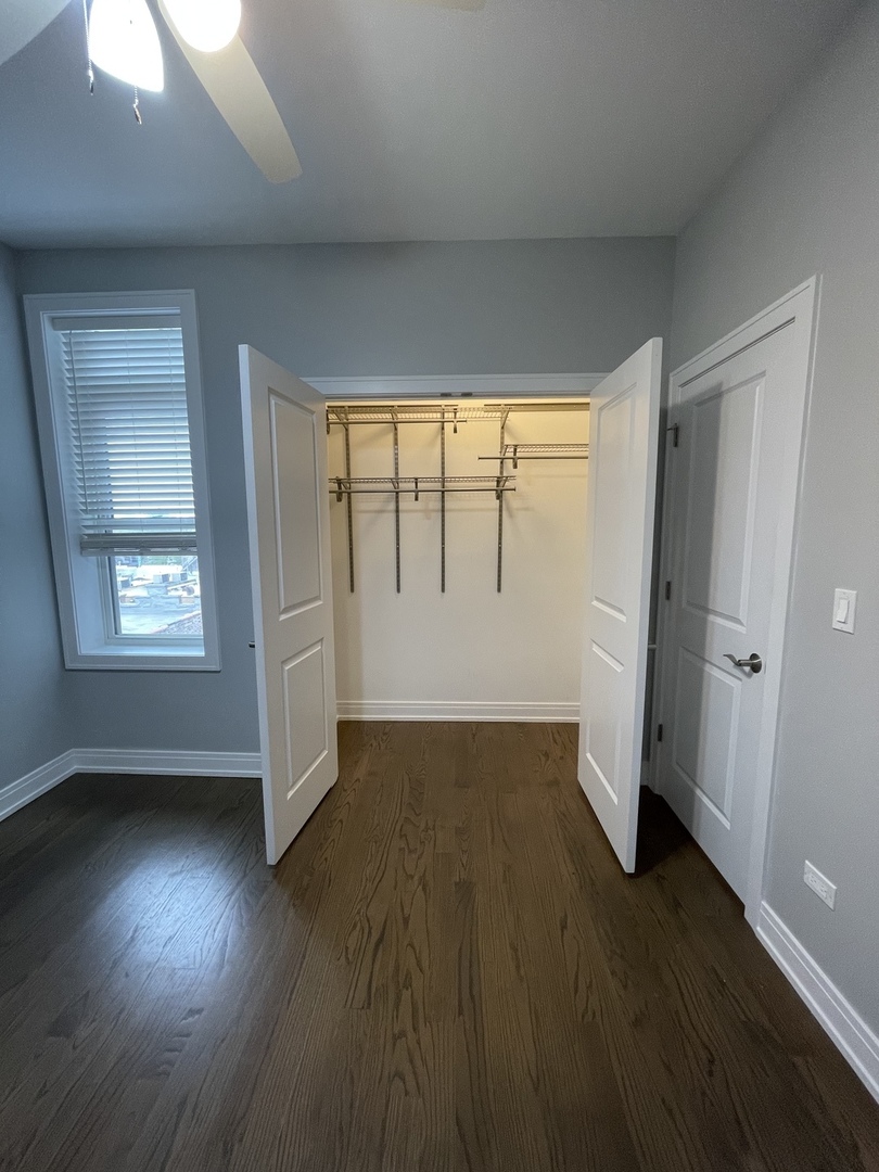 2036 West 18th Street, Unit 4 Chicago, IL 60608 - Photo 20 of 29 an empty room with wooden floor and windows