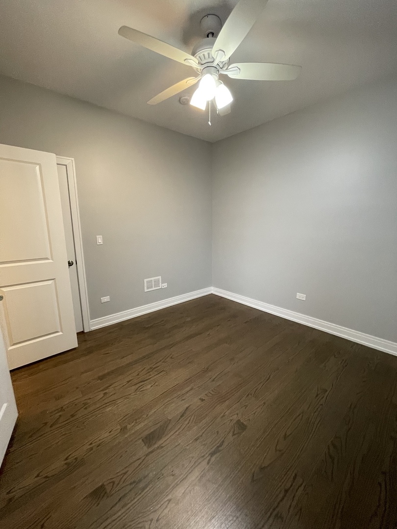 2036 West 18th Street, Unit 4 Chicago, IL 60608 - Photo 21 of 29 an empty room with wooden floor and fan