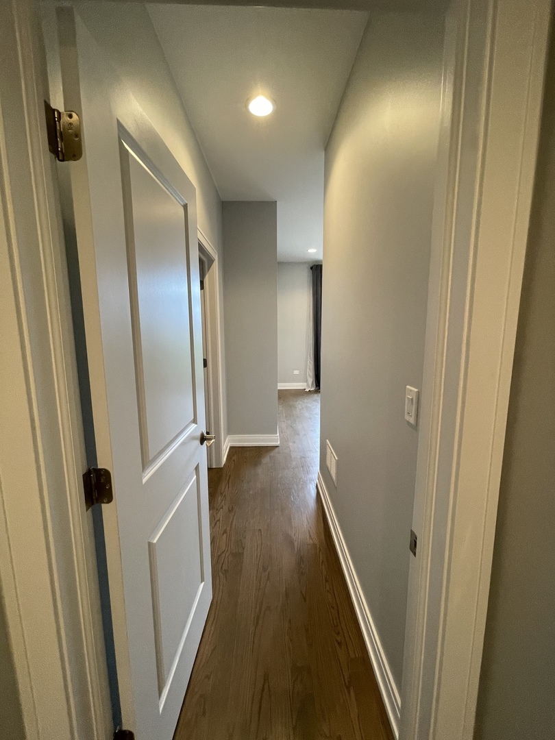 2036 West 18th Street, Unit 4 Chicago, IL 60608 - Photo 22 of 29 a view of a hallway with wooden floor