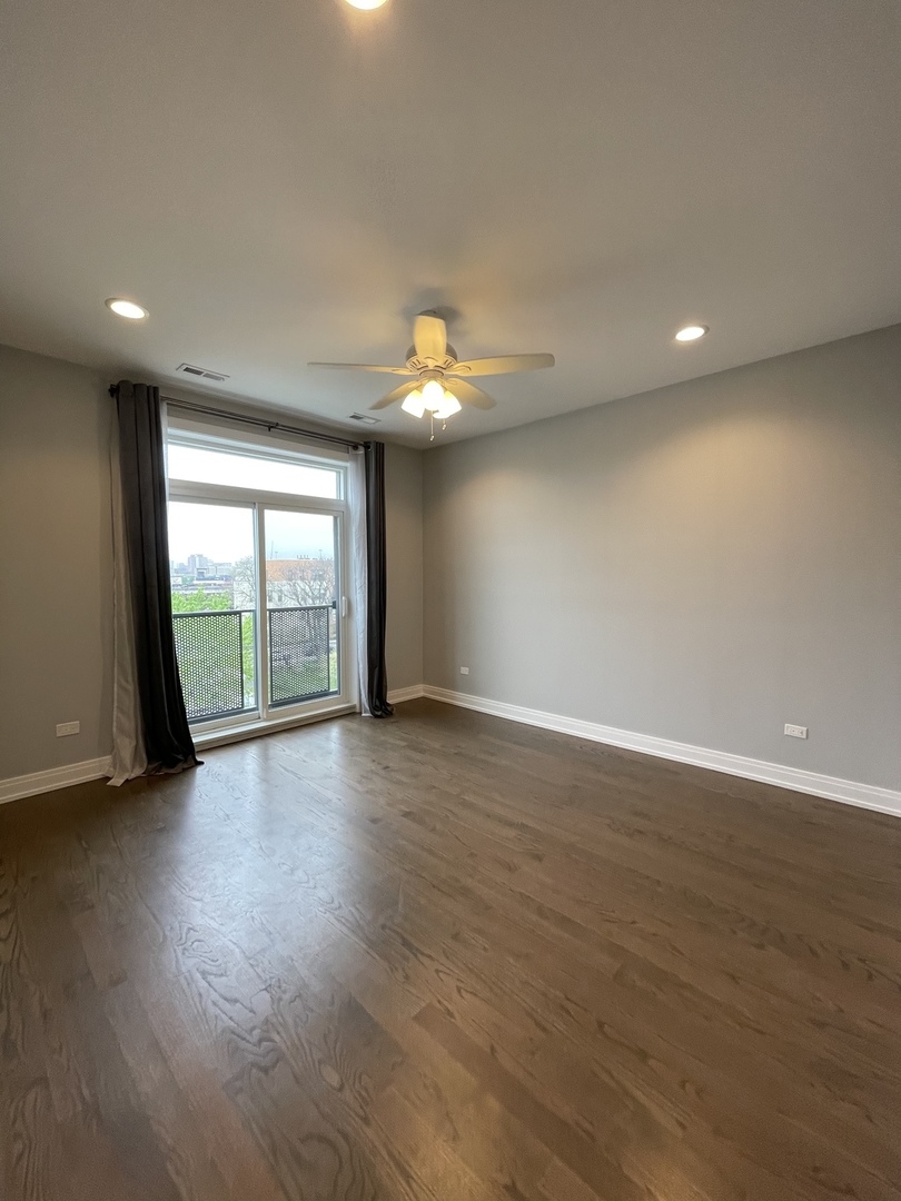 2036 West 18th Street, Unit 4 Chicago, IL 60608 - Photo 24 of 29 a view of an empty room with wooden floor and a window