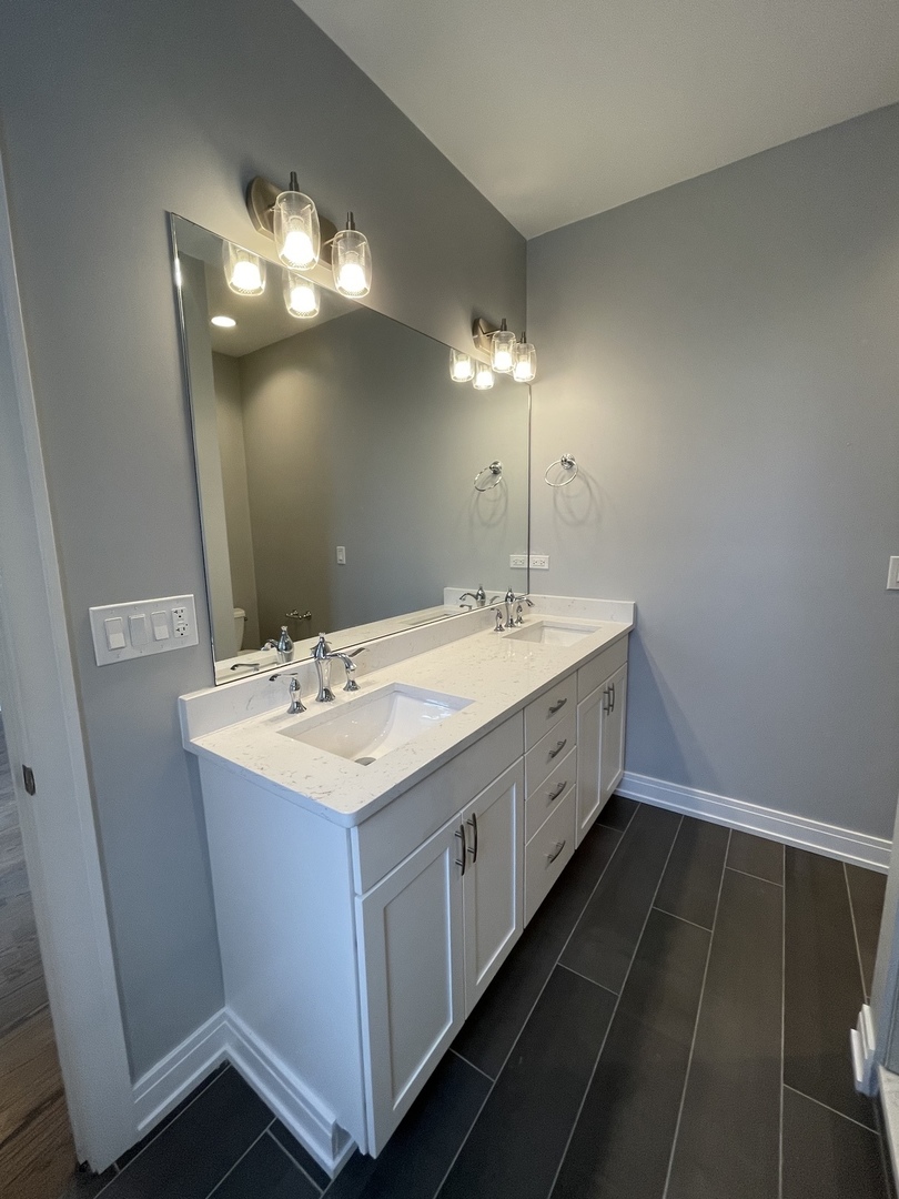 2036 West 18th Street, Unit 4 Chicago, IL 60608 - Photo 28 of 29 a spacious bathroom with a double vanity sink and a mirror