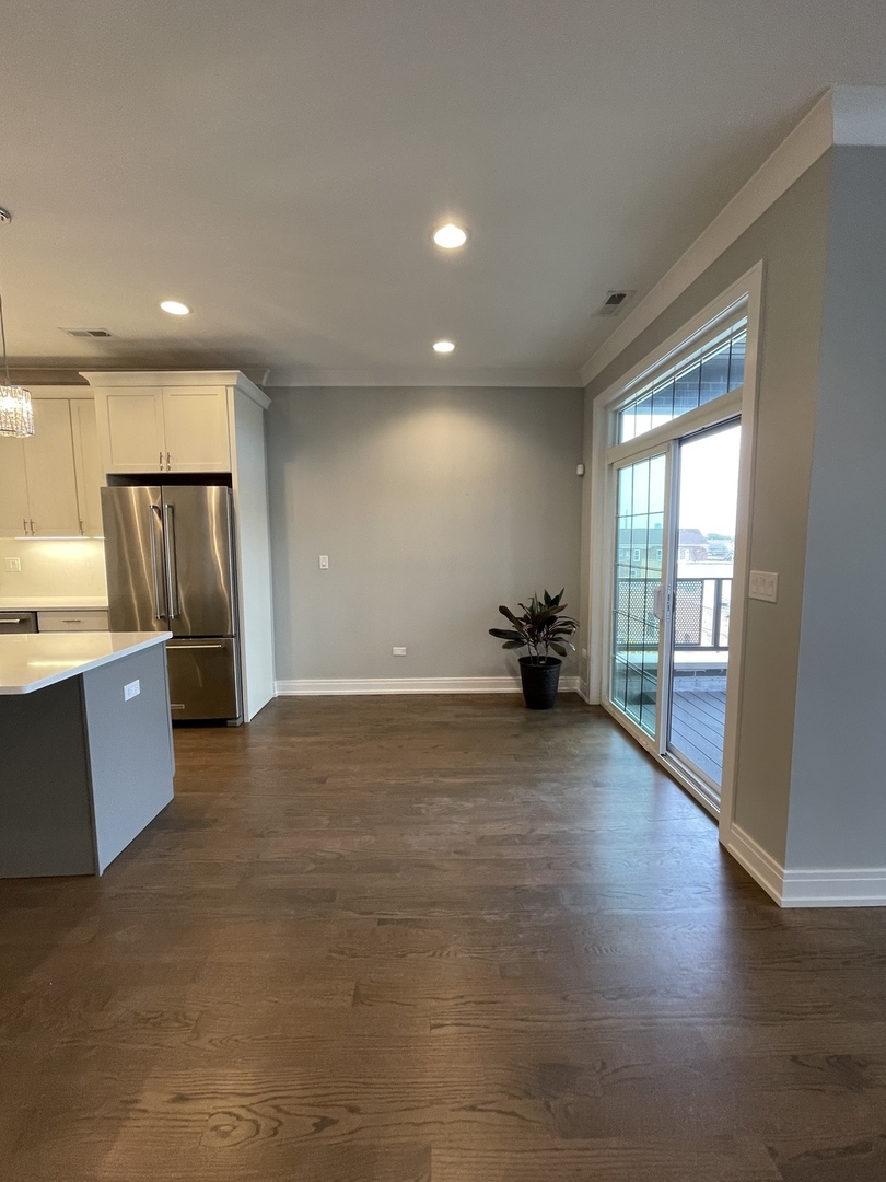 2036 West 18th Street, Unit 4 Chicago, IL 60608 - Photo 7 of 29 a view of a kitchen with a sink and a large window
