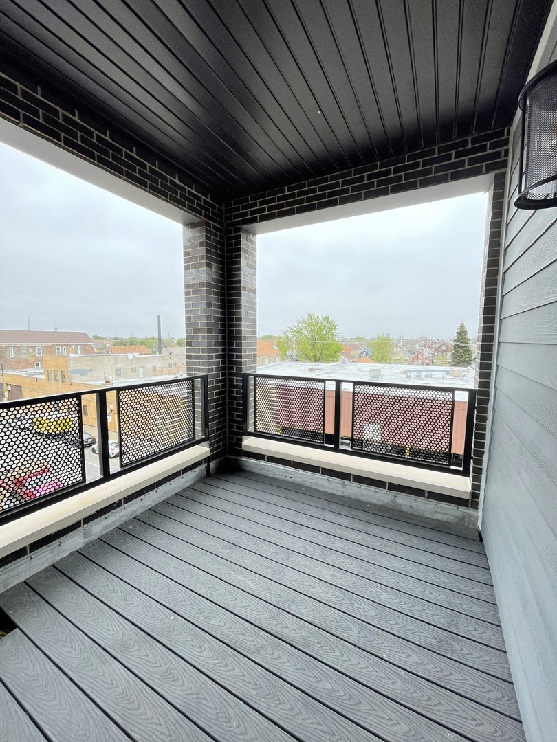 2036 West 18th Street, Unit 4 Chicago, IL 60608 - Photo 9 of 29 a view of a balcony with wooden floor