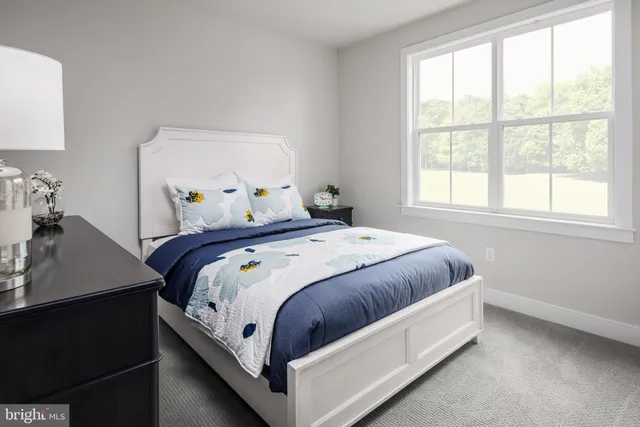 a bedroom with a bed and window