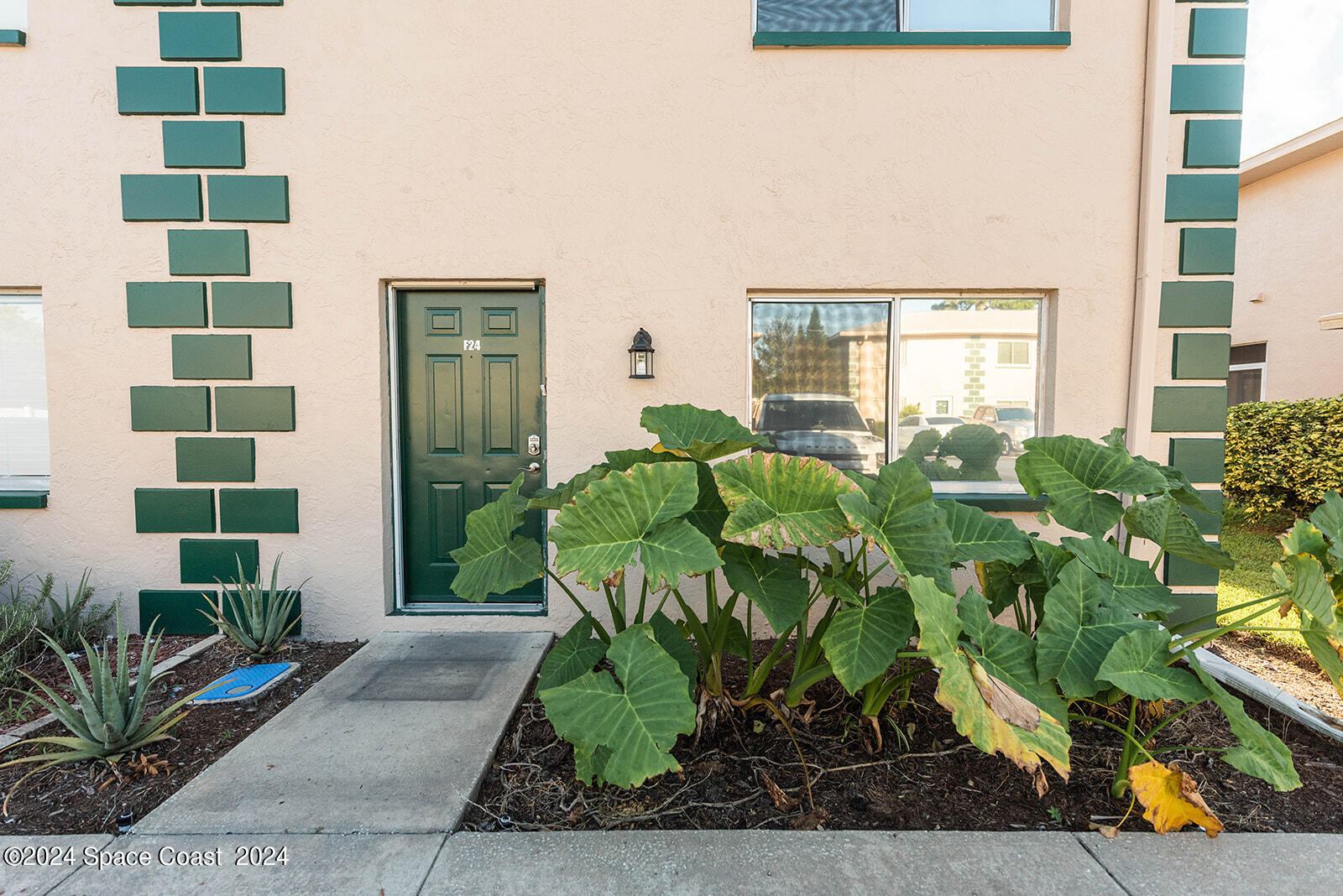 1880 Murrell Road, Unit F24 Rockledge, FL 32955 - Photo 1 of 45 a backyard of a house with potted plants