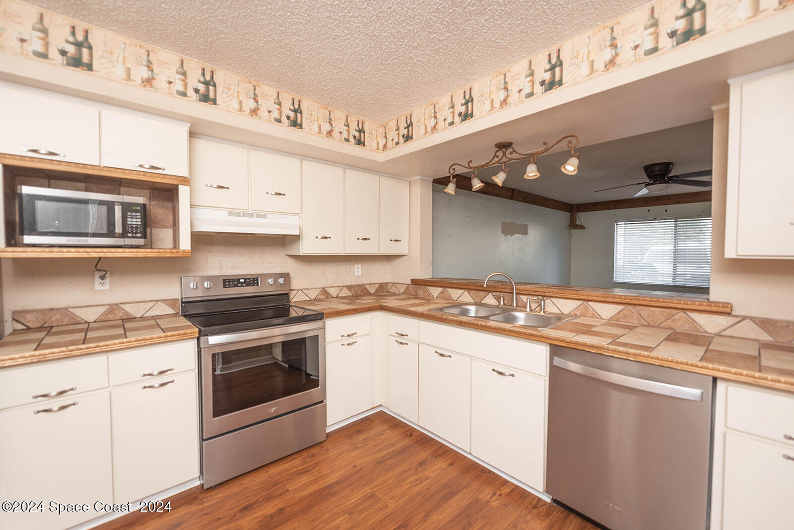 1880 Murrell Road, Unit F24 Rockledge, FL 32955 - Photo 12 of 45 a kitchen with stainless steel appliances granite countertop a sink and cabinets