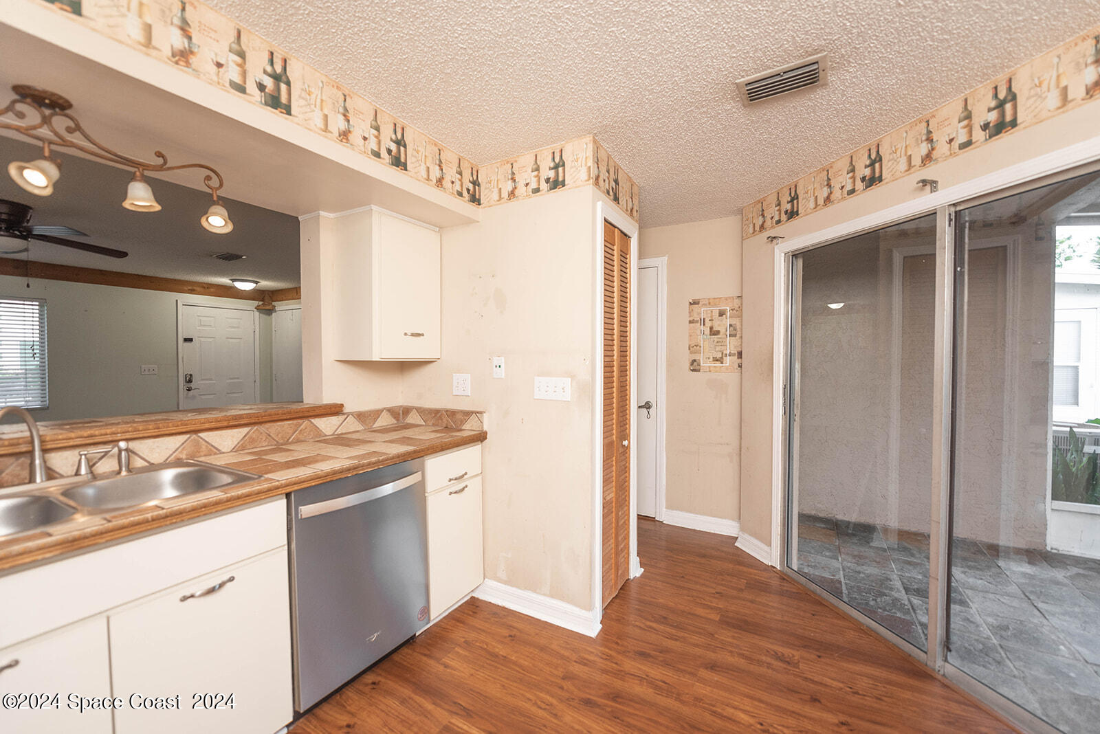 1880 Murrell Road, Unit F24 Rockledge, FL 32955 - Photo 13 of 45 a kitchen with stainless steel appliances granite countertop a sink and cabinets
