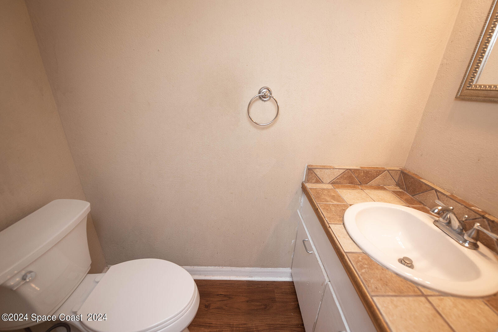 1880 Murrell Road, Unit F24 Rockledge, FL 32955 - Photo 17 of 45 a bathroom with a granite countertop toilet sink and mirror