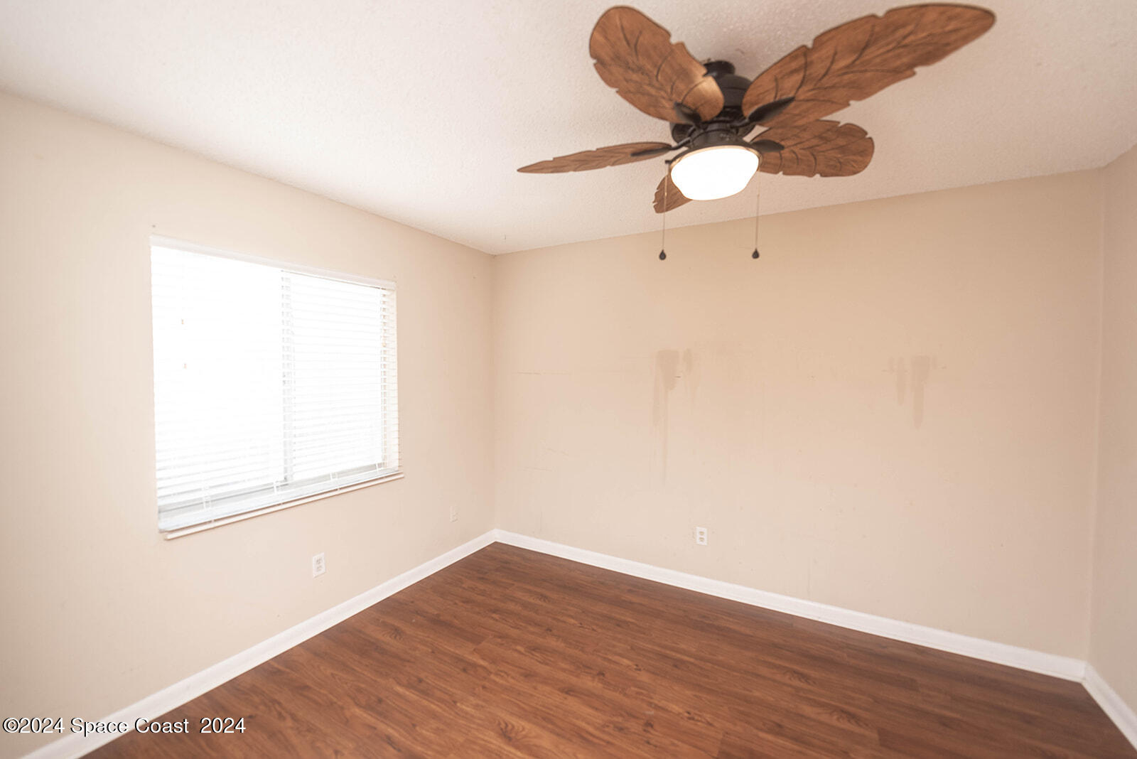 1880 Murrell Road, Unit F24 Rockledge, FL 32955 - Photo 22 of 45 a view of an empty room with wooden floor and a window