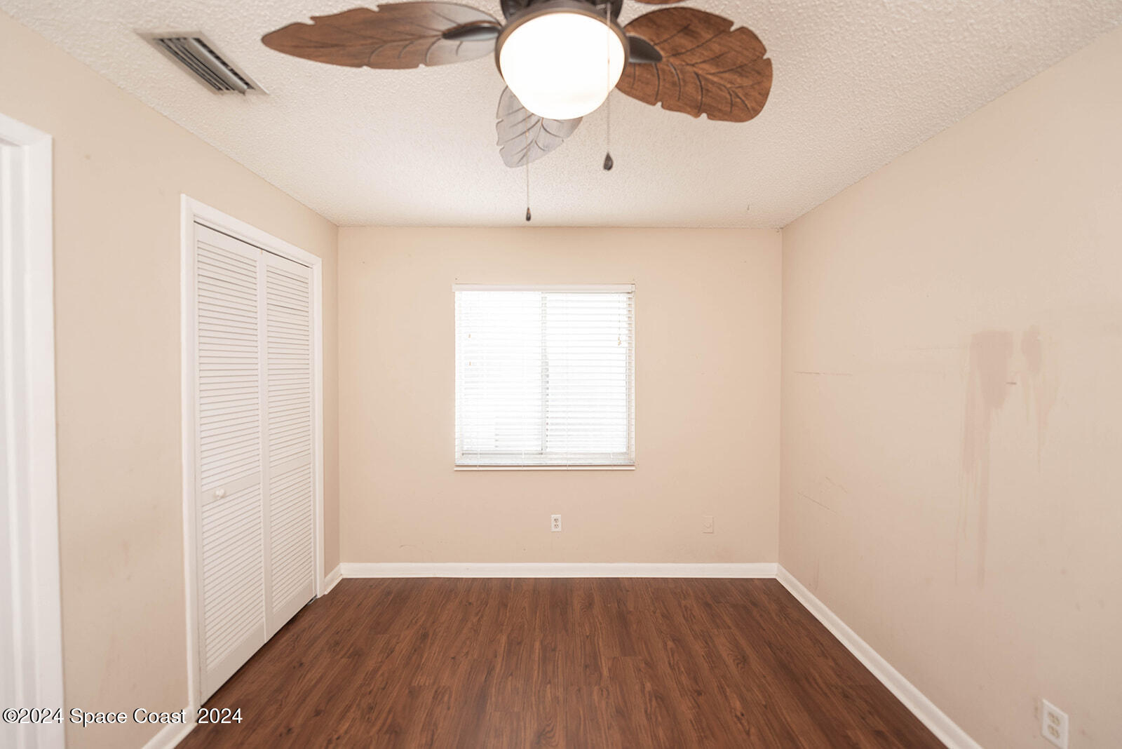 1880 Murrell Road, Unit F24 Rockledge, FL 32955 - Photo 23 of 45 an empty room with wooden floor and windows