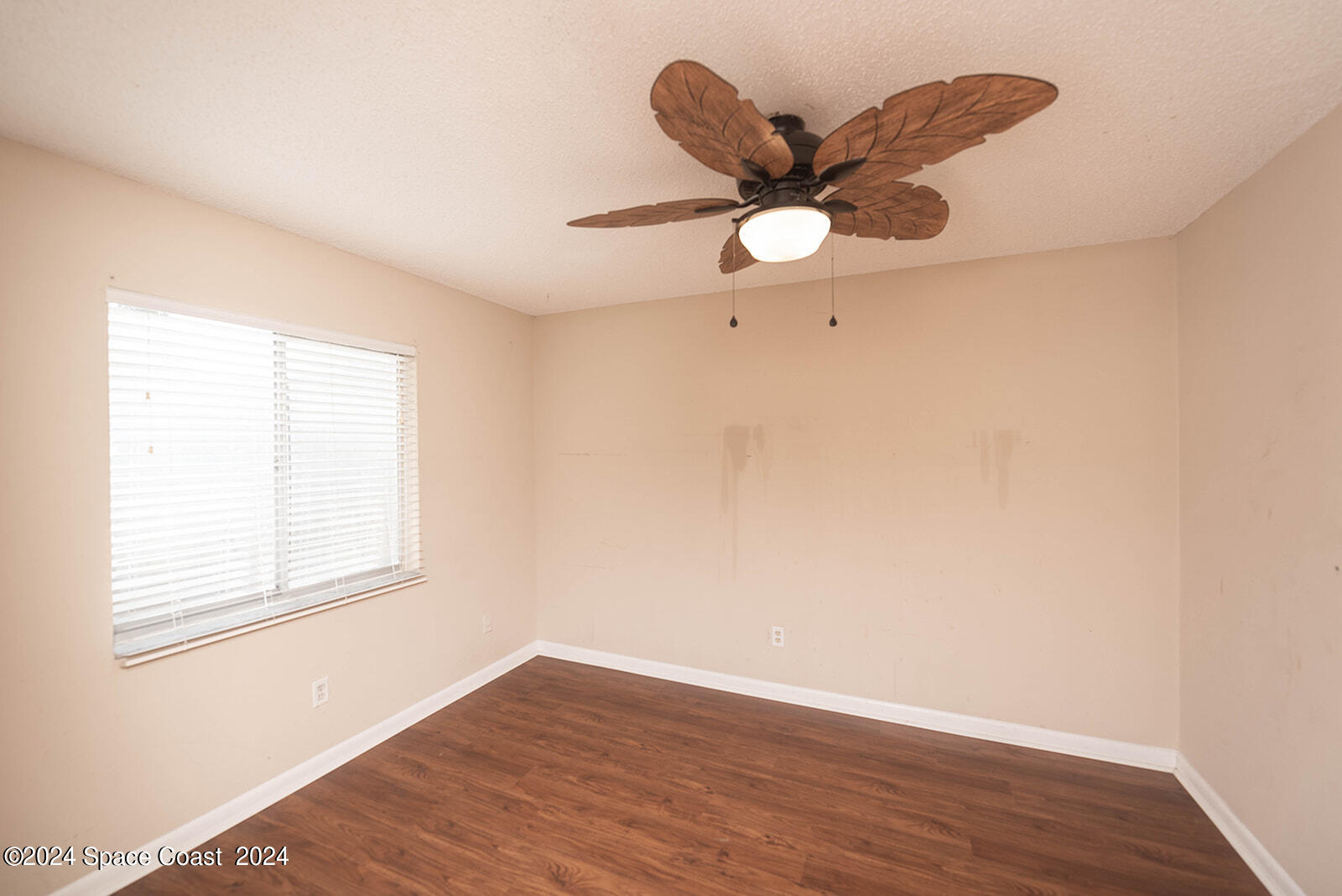 1880 Murrell Road, Unit F24 Rockledge, FL 32955 - Photo 24 of 45 an empty room with wooden floor fan and windows