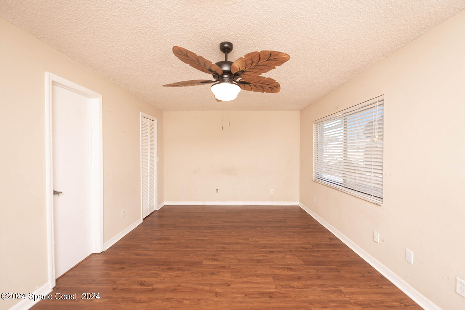 1880 Murrell Road, Unit F24 Rockledge, FL 32955 - Photo 28 of 45 a view of an empty room with window and a ceiling fan