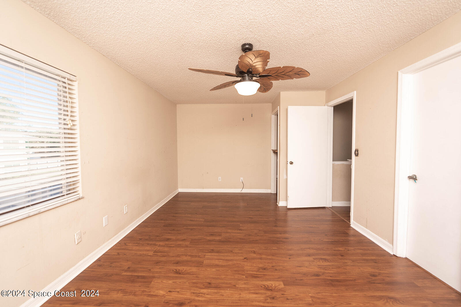 1880 Murrell Road, Unit F24 Rockledge, FL 32955 - Photo 30 of 45 a view of a room with wooden floor and chandelier