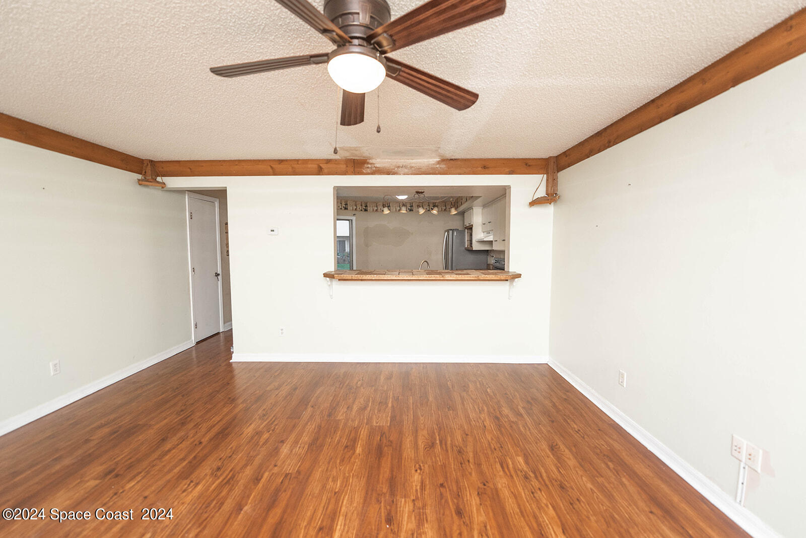 1880 Murrell Road, Unit F24 Rockledge, FL 32955 - Photo 3 of 45 a view of a room with wooden floor and a ceiling fan