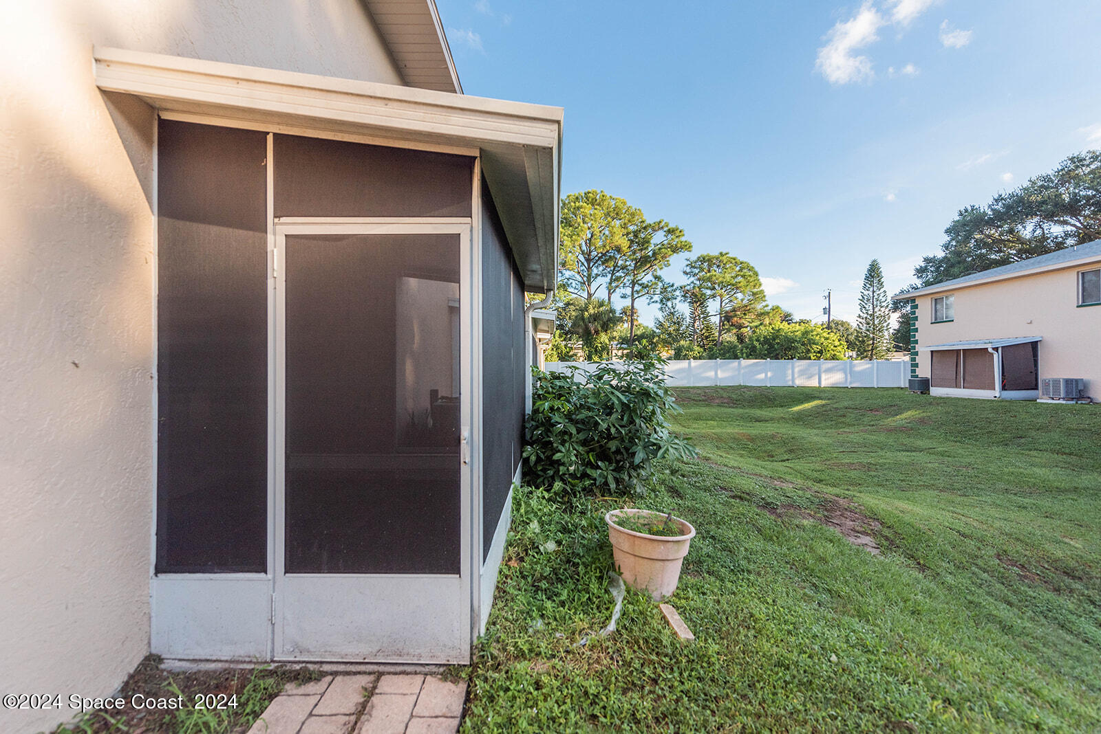 1880 Murrell Road, Unit F24 Rockledge, FL 32955 - Photo 39 of 45 a backyard of a house with outdoor seating and plants
