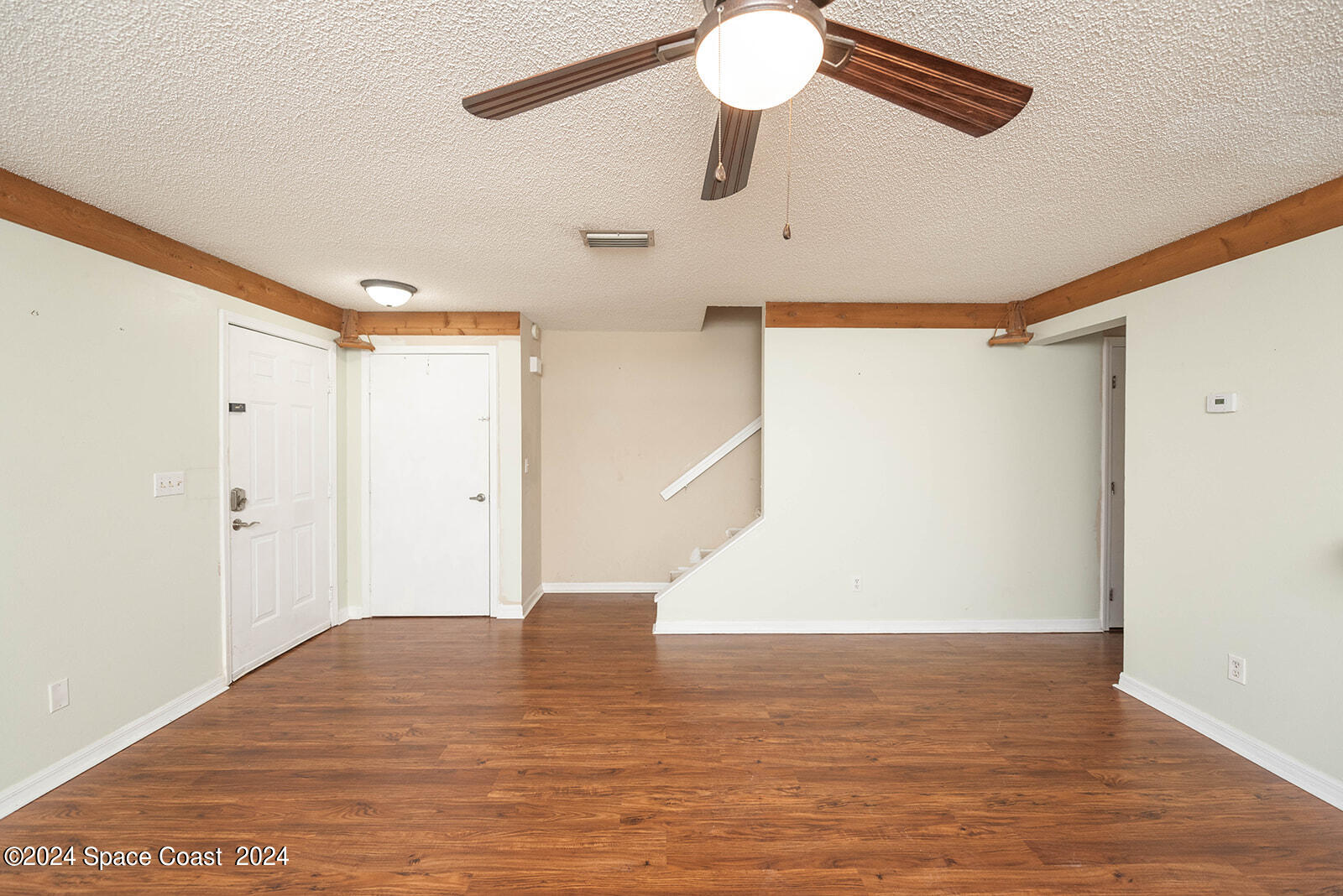 1880 Murrell Road, Unit F24 Rockledge, FL 32955 - Photo 5 of 45 a view of an empty room with wooden floor