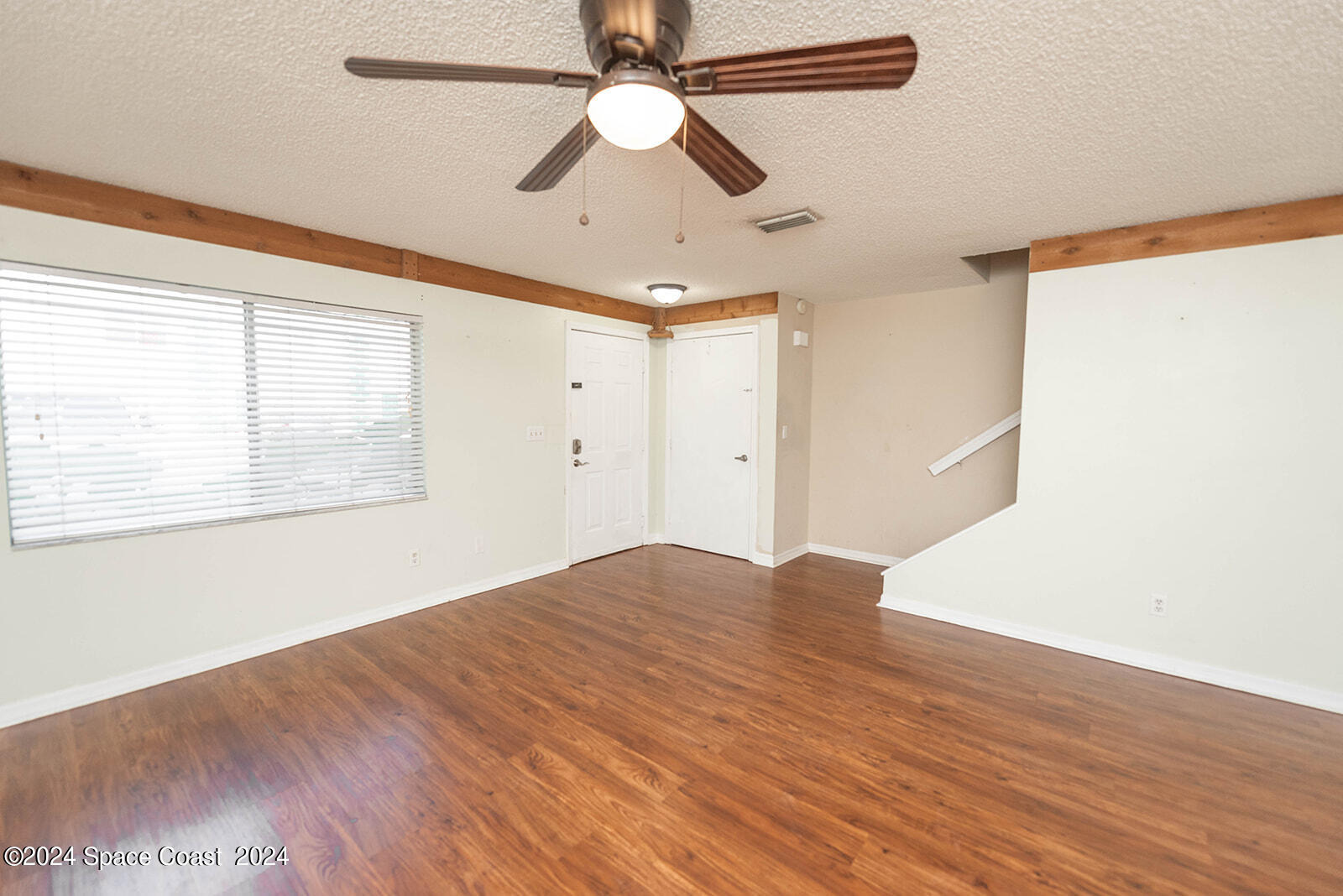 1880 Murrell Road, Unit F24 Rockledge, FL 32955 - Photo 6 of 45 a view of empty room with wooden floor and fan