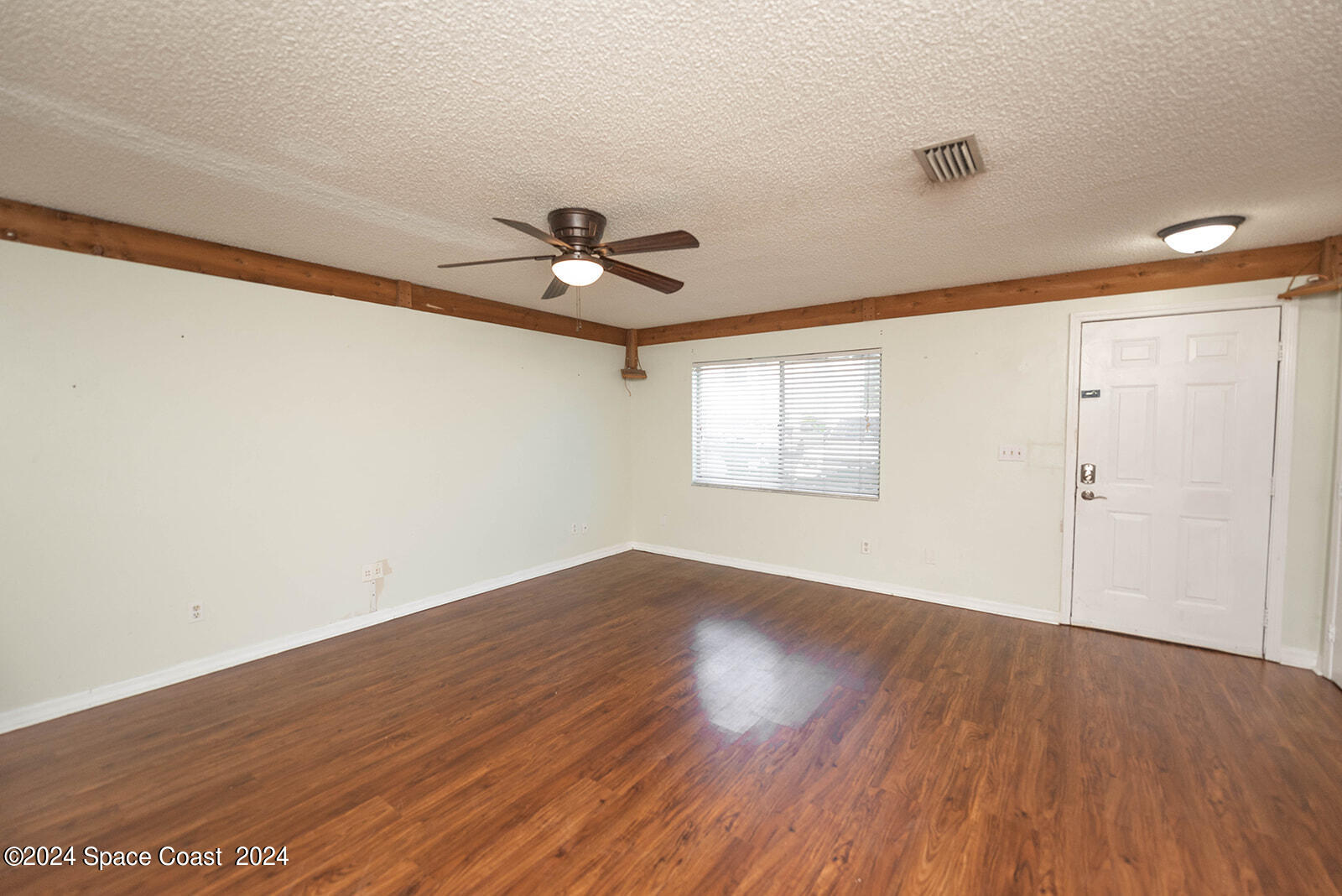 1880 Murrell Road, Unit F24 Rockledge, FL 32955 - Photo 9 of 45 wooden floor in an empty room with a window