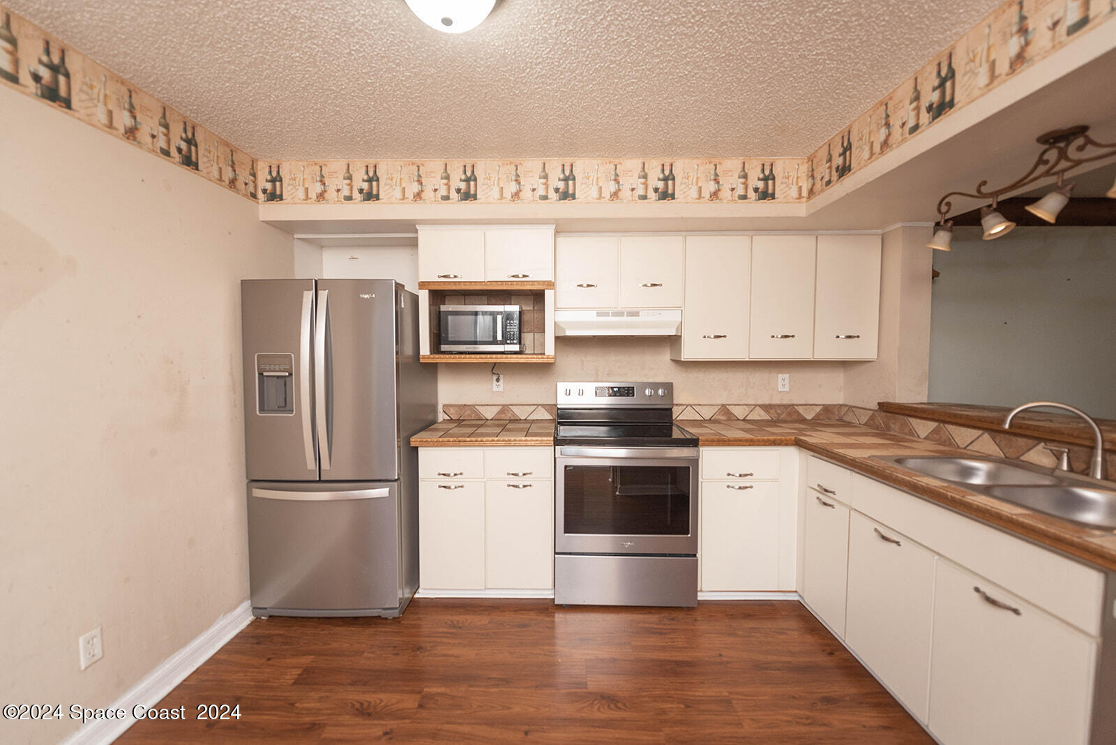 1880 Murrell Road, Unit F24 Rockledge, FL 32955 - Photo 10 of 45 a kitchen with stainless steel appliances granite countertop a refrigerator sink and stove