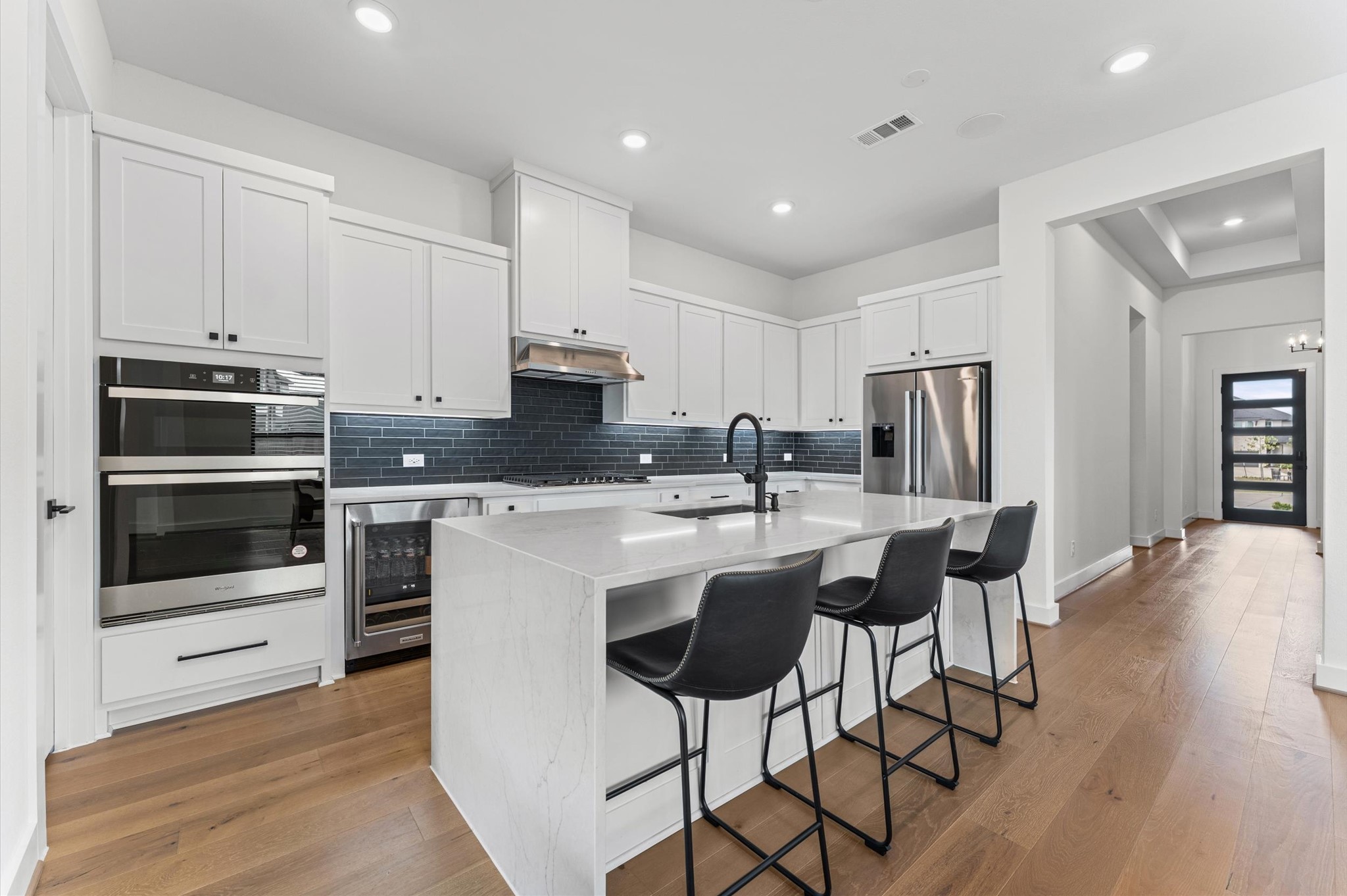 7327 Trial Rdg Drive Fulshear, TX 77441 - Photo 2 of 24 Built-in wall oven and microwave combo, stainless steel appliances, and quartz counters — a kitchen that actually makes cooking enjoyable.