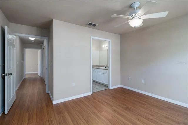 a view of an empty room with wooden floor