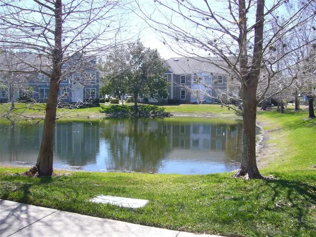 a view of a lake with a house in the background
