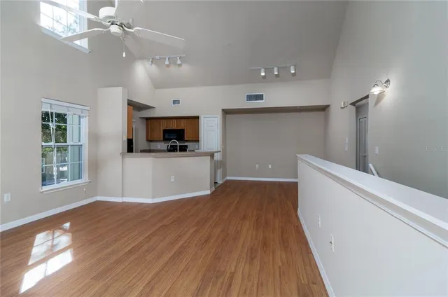 a view of a kitchen with a dishwasher cabinets and wooden floor