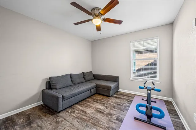 a living room with furniture and a ceiling fan