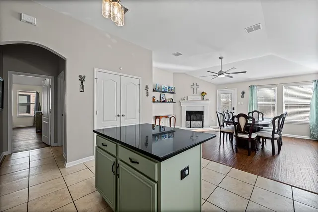 a kitchen with a sink a counter top space stainless steel appliances and cabinets
