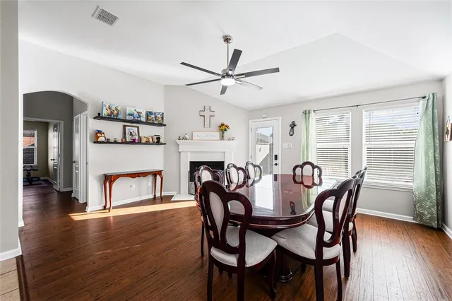 a kitchen with granite countertop a table chairs and a stove