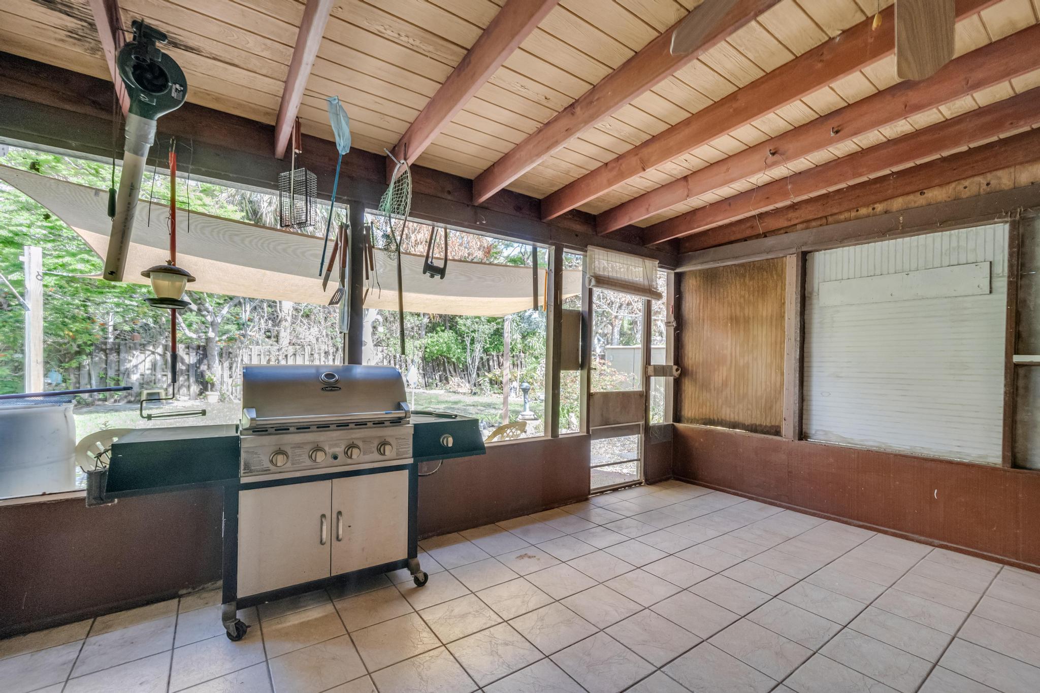 5406 Sunset Boulevard Fort Pierce, FL 34982 - Photo 22 of 33 a kitchen with stainless steel appliances granite countertop a sink and cabinets