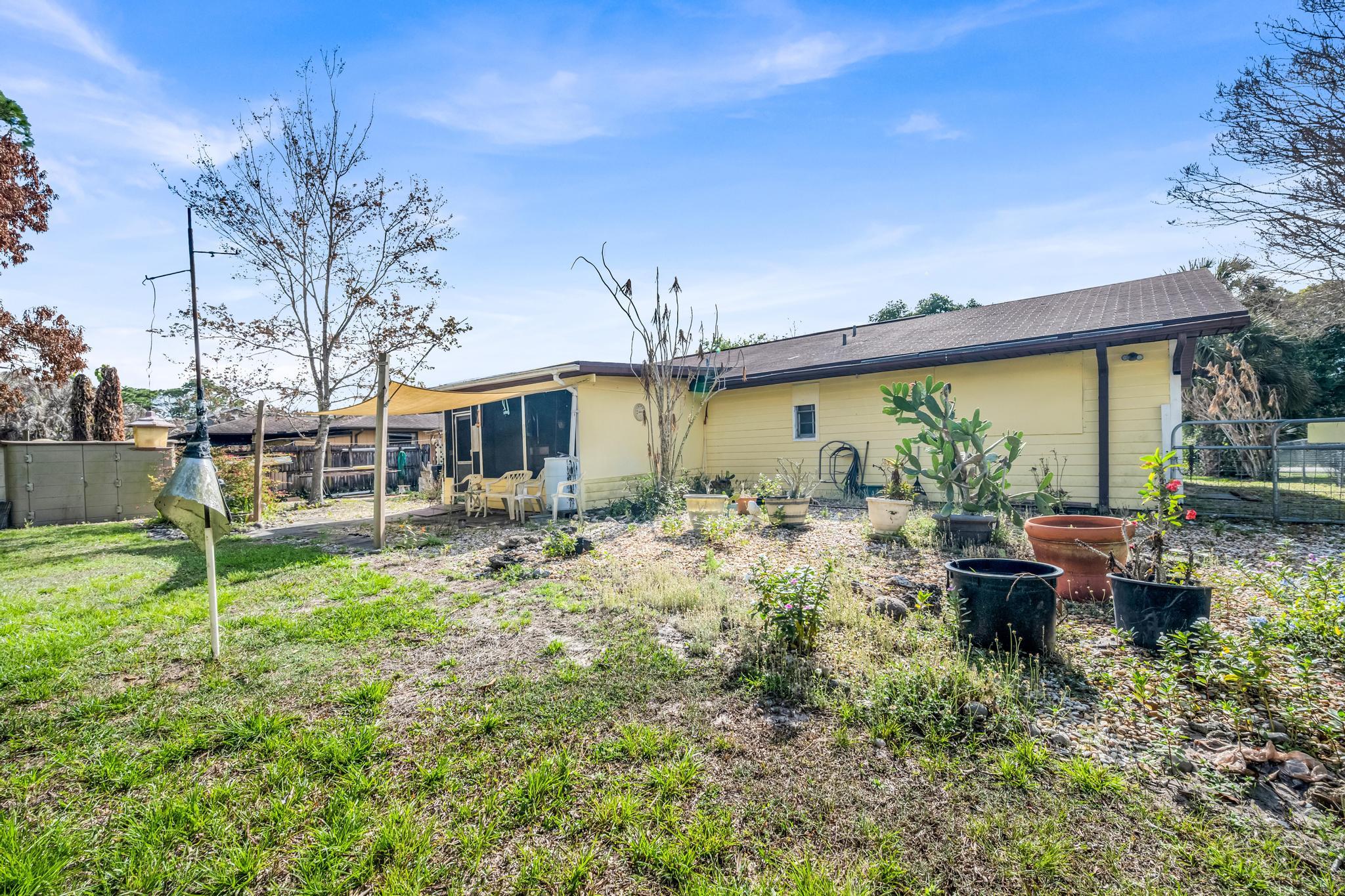 5406 Sunset Boulevard Fort Pierce, FL 34982 - Photo 24 of 33 a view of a house with backyard sitting area and garden